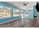 Bright living room with large windows overlooking the backyard, featuring light wood floors at 6067 Dana Dr, Norcross, GA 30093