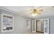 Bright living room featuring neutral walls, carpeted floors, a ceiling fan, and two large windows at 6067 Dana Dr, Norcross, GA 30093