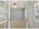 Bright living room featuring neutral walls, carpeted floors, a ceiling fan, and natural light at 6067 Dana Dr, Norcross, GA 30093