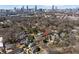 Aerial view of home in tree-lined neighborhood with Atlanta skyline in distance at 902 Edgewood Ne Ave, Atlanta, GA 30307