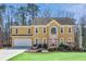 Charming two-story home with a manicured lawn, two car garage and mature landscaping at 1220 Lochshyre Way, Lawrenceville, GA 30043