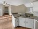 Bright kitchen view featuring a double sink, granite countertops, and wood flooring at 21 Fortson Dr, Hampton, GA 30228