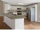 Well-lit kitchen features stainless steel appliances, ample cabinetry, and a granite countertop breakfast bar at 21 Fortson Dr, Hampton, GA 30228