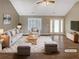 Bright living room showcasing modern decor, wood floors, and large windows at 21 Fortson Dr, Hampton, GA 30228