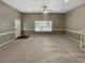 Spacious living room with a ceiling fan, carpet, base trim, and natural light at 21 Fortson Dr, Hampton, GA 30228