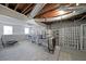 Spacious basement with exposed ceiling, brick accents, carpet, and ample storage space at 3114 Superior Dr, Dacula, GA 30019