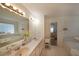 Bright bathroom featuring dual sinks, large vanity, and a soaking tub with crisp white towels at 3114 Superior Dr, Dacula, GA 30019