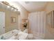 Classic bathroom features a single sink vanity, decorative wallpaper, and a shower-tub combination at 3114 Superior Dr, Dacula, GA 30019