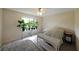 Sunny bedroom with a large window filled with house plants and a cozy bed with rug at 3114 Superior Dr, Dacula, GA 30019