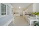 Well-lit kitchen with white cabinets, ample counter space, and modern appliances at 3114 Superior Dr, Dacula, GA 30019