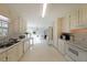 A well lit all-white kitchen with window views into the living room and other parts of the house at 3114 Superior Dr, Dacula, GA 30019