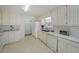 An all-white kitchen features matching cabinets, countertops and appliances with plenty of storage space at 3114 Superior Dr, Dacula, GA 30019