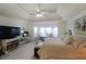 Large main bedroom with a bay window, and comfortable seating. A ceiling fan provides added comfort at 3114 Superior Dr, Dacula, GA 30019