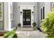 Charming front entrance with black double doors, stylish lighting, and manicured landscaping at 435 10Th Ne St # 18, Atlanta, GA 30309