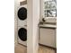 Functional laundry area with stacked washer and dryer units, along with a countertop and storage space at 435 10Th Ne St # 18, Atlanta, GA 30309