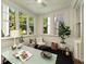 Bright sunroom featuring large windows, a ceiling fan, and a desk setup for a relaxing workspace at 435 10Th Ne St # 18, Atlanta, GA 30309