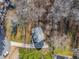 Aerial shot of a home nestled in a wooded area, showcasing its driveway and surrounding trees at 504 Hanover Ct, Woodstock, GA 30188