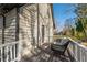 Comfortable back porch with a white railing, wicker furniture, and an outdoor rug at 504 Hanover Ct, Woodstock, GA 30188