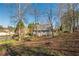 Backyard view of a home with a spacious yard, perfect for outdoor enjoyment and activities at 504 Hanover Ct, Woodstock, GA 30188