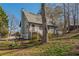 Backyard view of the home highlighting the deck, fenced yard, and lush greenery, offering privacy and outdoor enjoyment at 504 Hanover Ct, Woodstock, GA 30188