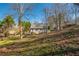 Backyard view of a home showcasing an expansive lawn and natural surroundings at 504 Hanover Ct, Woodstock, GA 30188
