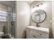 Bright bathroom features a glass shower door, toilet, vanity with sink, and modern lighting fixture at 504 Hanover Ct, Woodstock, GA 30188