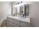 Modern bathroom features double sinks, vanity with grey cabinets, and black hardware at 504 Hanover Ct, Woodstock, GA 30188