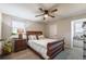 Inviting bedroom showcases a ceiling fan, a stylish bed, and a large window at 504 Hanover Ct, Woodstock, GA 30188