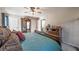 Comfortable bedroom features a ceiling fan, hardwood furniture, and soothing color scheme at 504 Hanover Ct, Woodstock, GA 30188