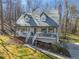 Elevated view of a charming two-story home featuring a cozy front porch and a well-manicured lawn surrounded by mature trees at 504 Hanover Ct, Woodstock, GA 30188