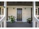 Close-up of the inviting front door with elegant fixtures and planters at 504 Hanover Ct, Woodstock, GA 30188