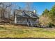 Exterior shot of a charming two-story home with a welcoming front porch and well-maintained lawn at 504 Hanover Ct, Woodstock, GA 30188