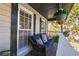 Relaxing front porch area with comfortable seating and hanging flower baskets at 504 Hanover Ct, Woodstock, GA 30188