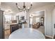 Open concept kitchen with white cabinets and stainless steel appliances, adjacent to the living room at 504 Hanover Ct, Woodstock, GA 30188