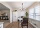 Eat-in kitchen featuring white cabinets and a modern chandelier, with a view to the living area at 504 Hanover Ct, Woodstock, GA 30188