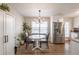 Open concept kitchen with white cabinets and stainless steel appliances, adjacent to the dining area at 504 Hanover Ct, Woodstock, GA 30188