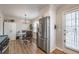 Eat-in kitchen featuring white cabinets and stainless steel appliances, located near a door leading to the outside at 504 Hanover Ct, Woodstock, GA 30188