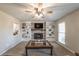 Cozy living room featuring a fireplace with built-in shelving and ample natural light at 504 Hanover Ct, Woodstock, GA 30188