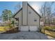 This home includes a two-car garage, exterior chimney, and an elevated rear deck, perfect for outdoor enjoyment at 504 Hanover Ct, Woodstock, GA 30188