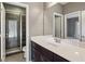 Bathroom features a vanity with a white countertop, dark wood cabinets, a mirror, and a glass shower at 1620 Copperleaf Nw Ct, Kennesaw, GA 30152