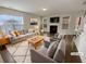 Cozy living room featuring a fireplace, large windows, and stylish neutral-toned furniture at 272 Laurel Canyon Pkwy, Canton, GA 30114
