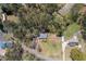 Aerial view of a home with lush trees, a detached garage, and a large garden at 4693 Sugar Hill Se Rd, Acworth, GA 30102