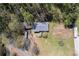 Aerial view of home featuring mature trees, detached garage, and a cultivated garden area at 4693 Sugar Hill Se Rd, Acworth, GA 30102