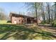 Two-story brick home featuring an expansive backyard and a wooden deck with access to the lush surroundings at 4693 Sugar Hill Se Rd, Acworth, GA 30102