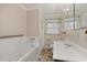 Bathroom with a soaking tub, sink, and tiled flooring at 4693 Sugar Hill Se Rd, Acworth, GA 30102