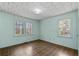 Bedroom featuring hardwood floors, two windows, and light-colored walls at 4693 Sugar Hill Se Rd, Acworth, GA 30102