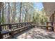 Large deck featuring built-in seating and offering a relaxing space surrounded by natural woodland views at 4693 Sugar Hill Se Rd, Acworth, GA 30102