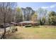 A single-story brick home with a large front yard, RV, and detached garage at 4693 Sugar Hill Se Rd, Acworth, GA 30102