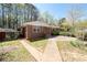 Charming brick home with a sidewalk leading to the front entrance and mature shrubs at 4693 Sugar Hill Se Rd, Acworth, GA 30102