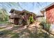 Back of a brick house with a wooden deck and stairs at 4693 Sugar Hill Se Rd, Acworth, GA 30102